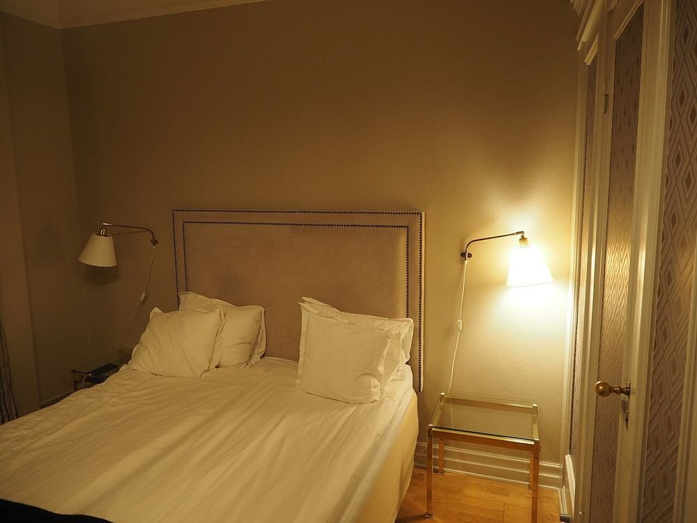 Comfortable hotel room with bed and lamp